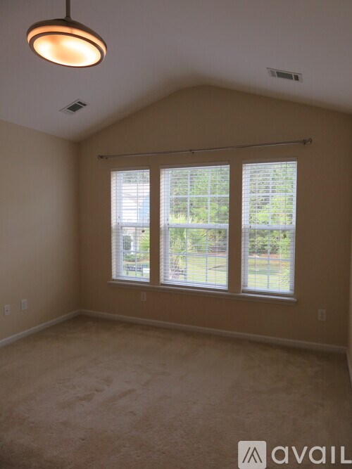 A room with a window and a ceiling light.