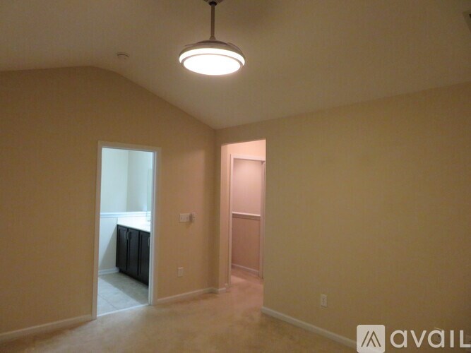 A room with beige walls and a ceiling light.