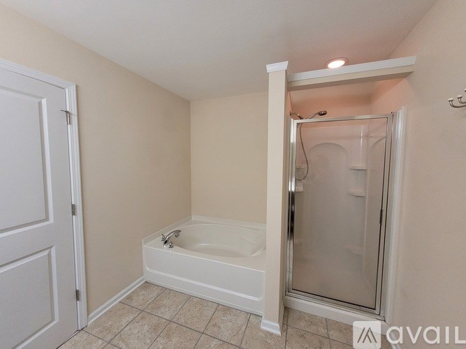 A bathroom with a toilet, sink, and mirror.