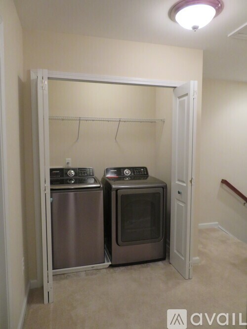 A small laundry room with a washer and dryer.
