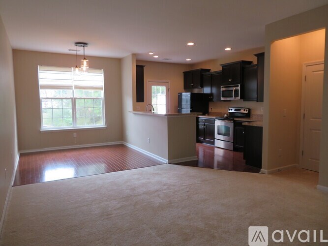 A kitchen with black cabinets and appliances is shown in the image.