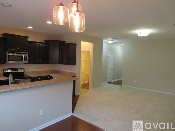 A kitchen with black cabinets and a granite countertop.