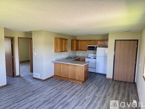 A kitchen with wooden cabinets and a white refrigerator.