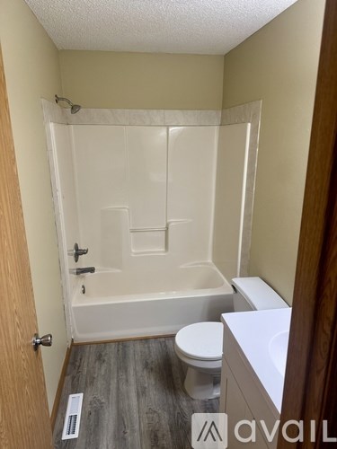 A bathroom with a toilet, sink, and bathtub.