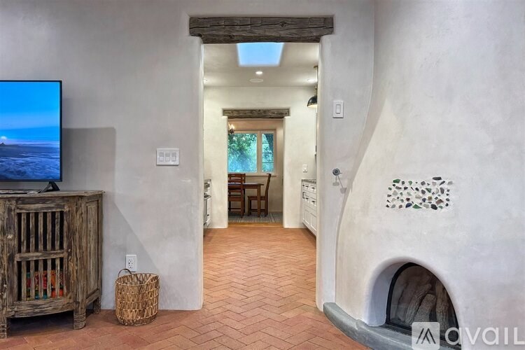 A living room with a flat screen TV and a fireplace.