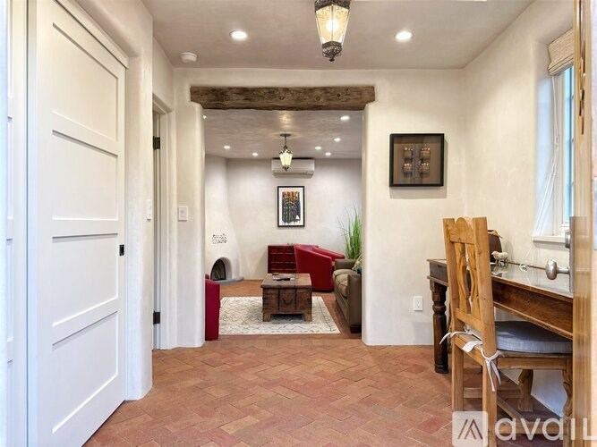 A room with a wooden floor and a white door.