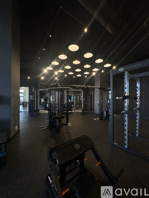 A gym with a variety of equipment including a treadmill.