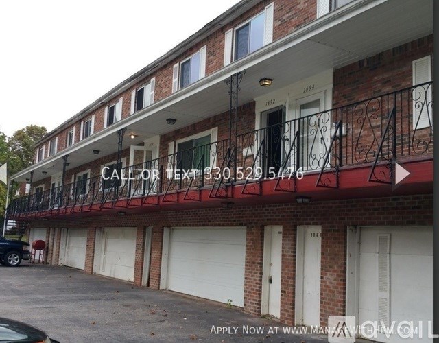 A building with a sign that says "CALL OR EXT 530.529 54776" on the balcony.