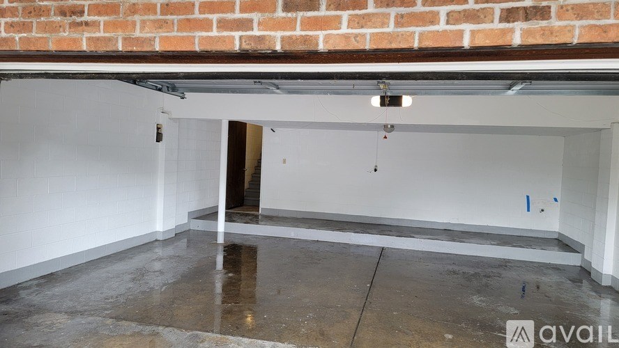 A room with a white wall and a concrete floor.