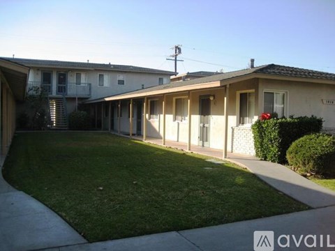 A sunny day at a residential area with houses and green lawns.