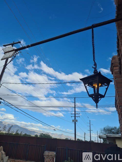 A street lamp is hanging from a wire.