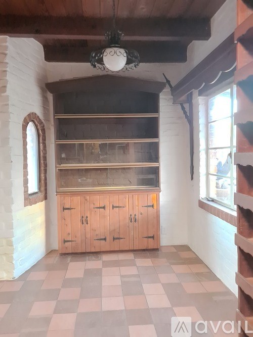 A room with wooden cabinets and a checkered floor.