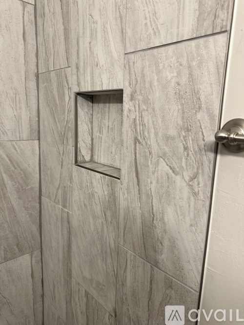 A shower door with a square cutout in the middle.