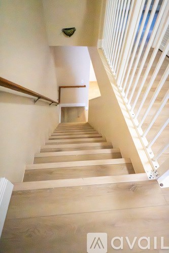 A staircase with wooden steps and white railings.