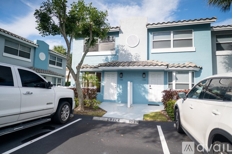 A wooden deck with a white fence.