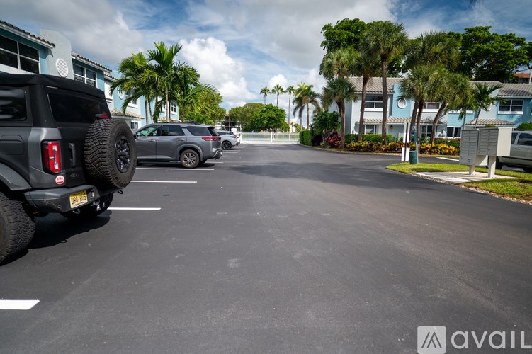 A black off-road vehicle is parked in a parking lot.