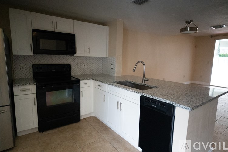 A kitchen with granite countertops and stainless steel appliances.
