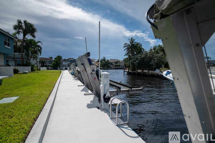 A row of boats are docked at a marina.