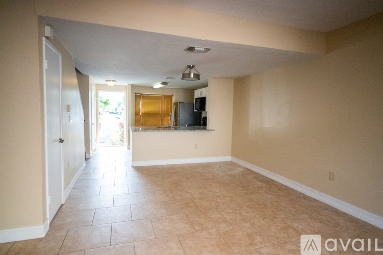 A room with wooden flooring and a ceiling fan.