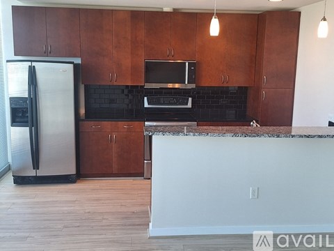 A kitchen with brown cabinets and a white island.