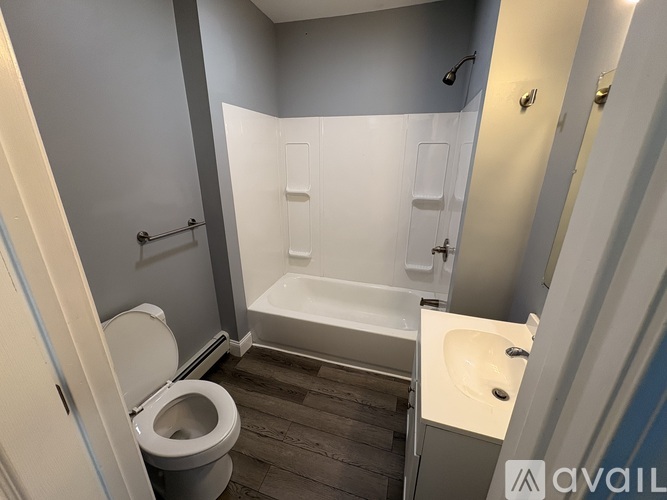 A bathroom with a toilet, sink, and bathtub.