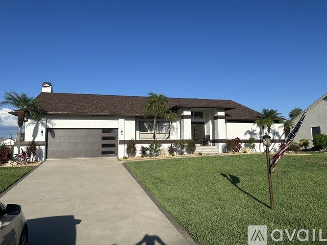 A house with a flag on a pole in front of it.