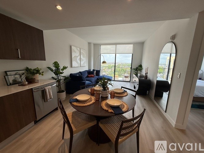 A modern kitchen with a dining table set for two.