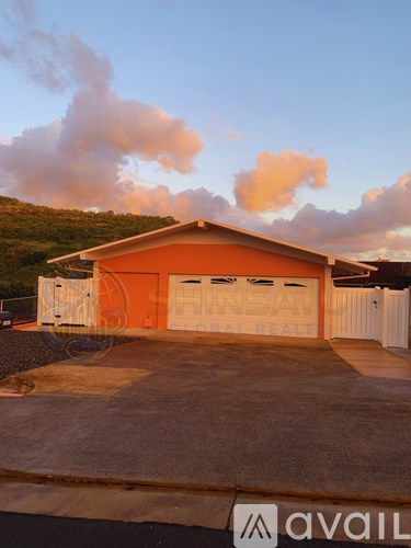 A two-car garage with a brown roof and white trim.