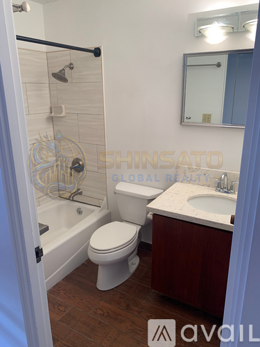 A bathroom with a toilet, sink, and bathtub.
