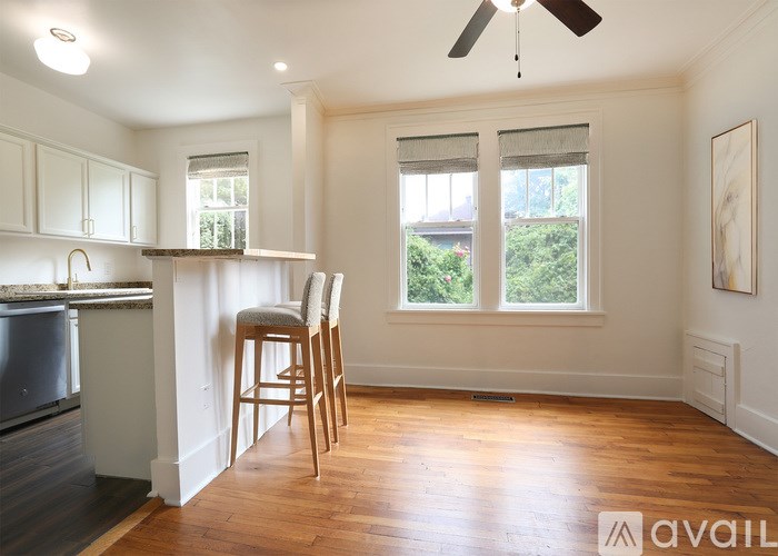 A kitchen with wooden floors and a bar area.
