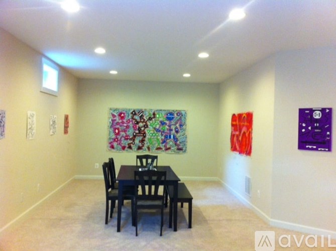 A dining room with a table and chairs.