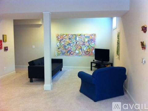 A living room with a blue couch and a television.