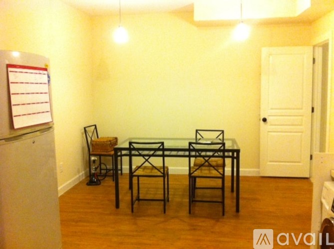 A room with a glass table and chairs.