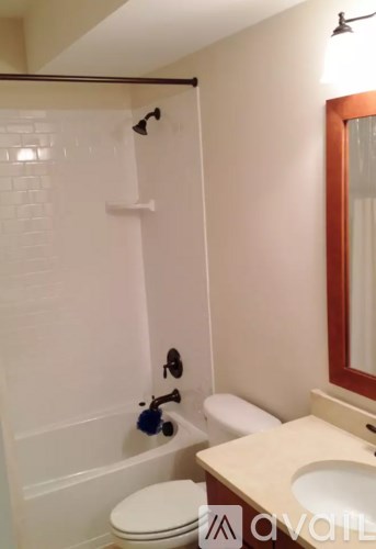 A white toilet sits next to a sink in a bathroom.