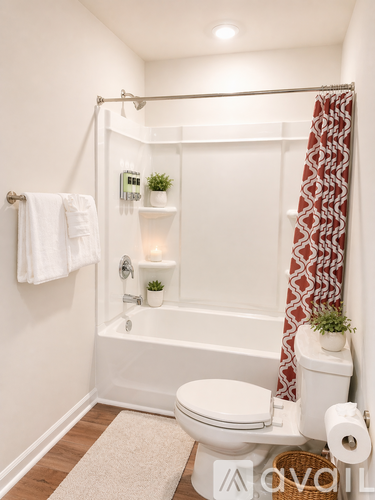 A white toilet sits next to a bathtub in a bathroom.