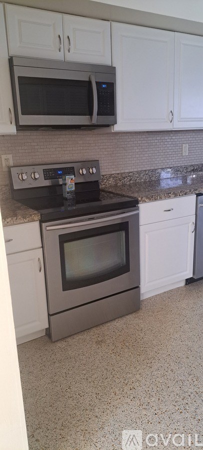 A kitchen with a stove top oven and microwave above it.