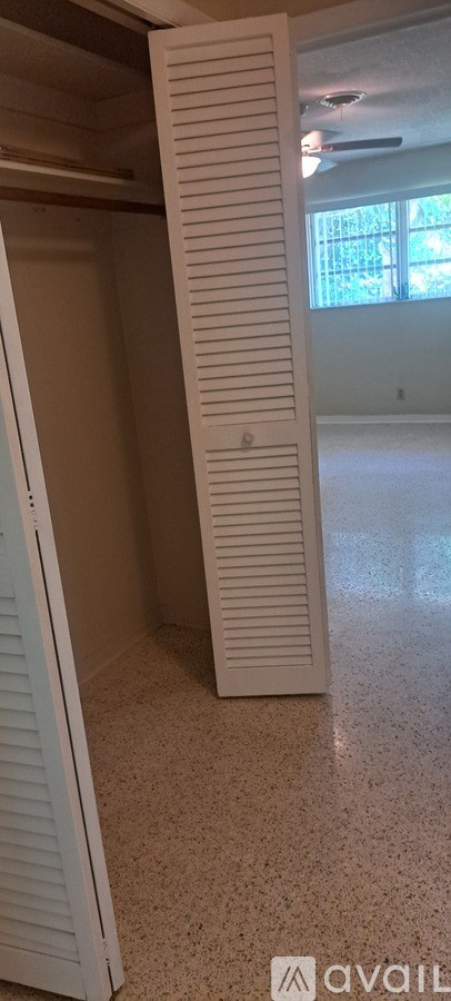 A room with a white door and a window.