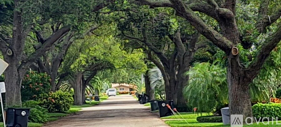 A kitchen with white cabinets and a ceiling fan.
