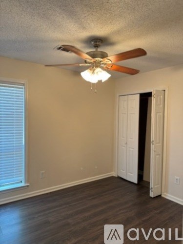 A room with a ceiling fan and a light fixture.