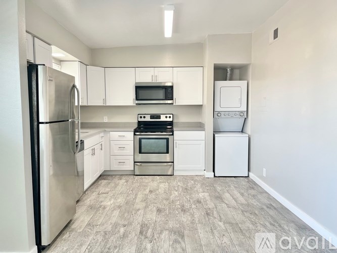A kitchen with a refrigerator, oven, microwave, and dishwasher.