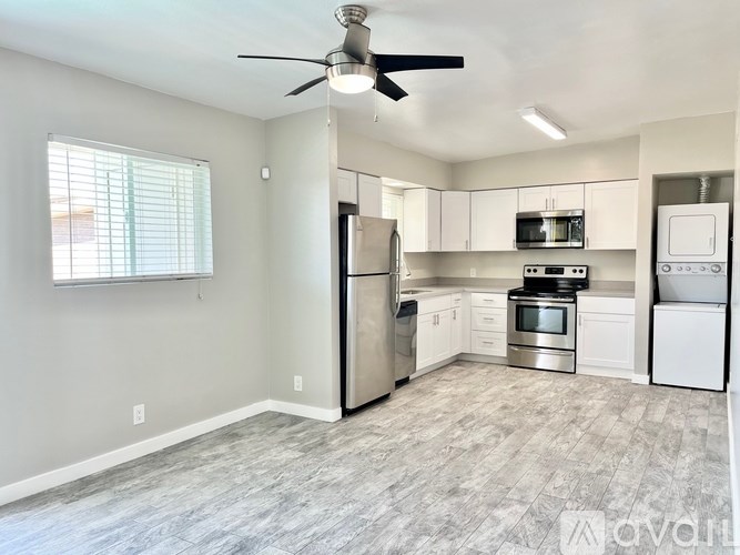 A kitchen with a refrigerator, oven, and microwave.
