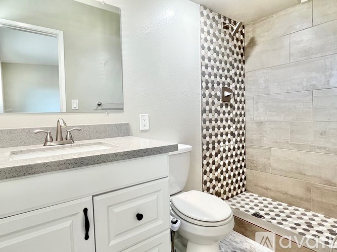 A white toilet sits next to a sink in a bathroom.