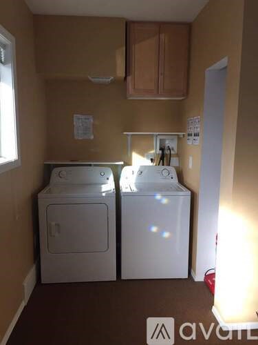 A small laundry room with a washer and dryer.