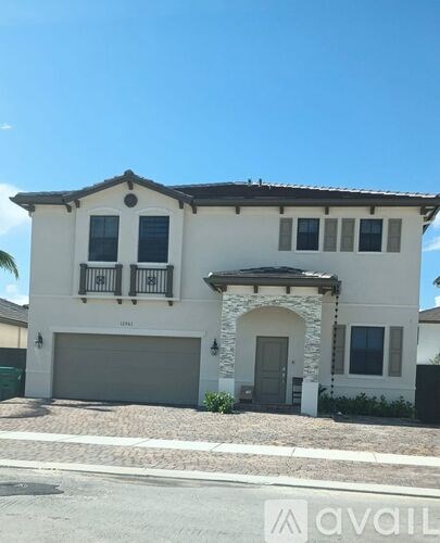 A two-story house with a garage is for sale.