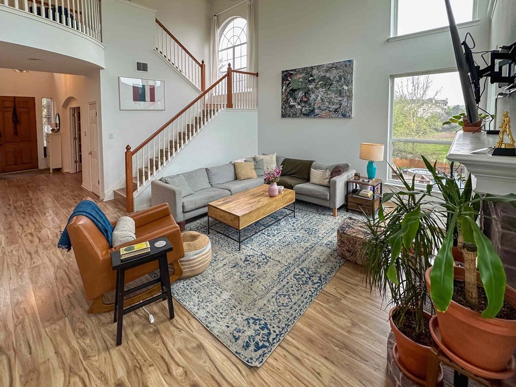 A living room with a staircase and a couch.
