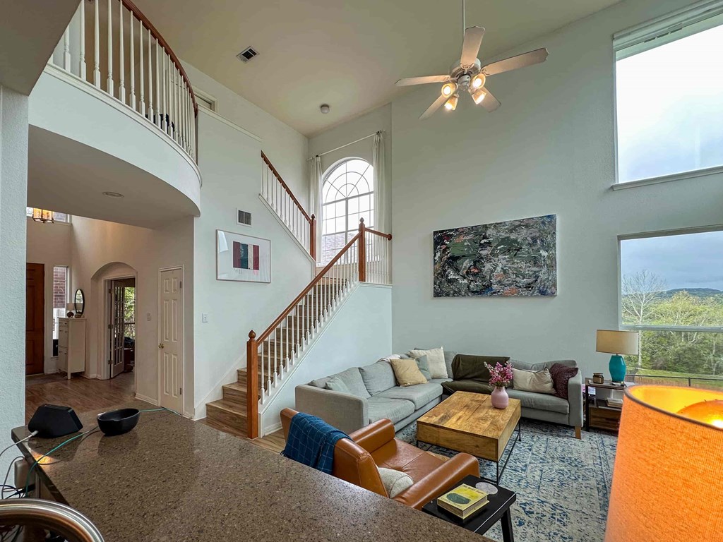 A living room with a staircase and a couch.
