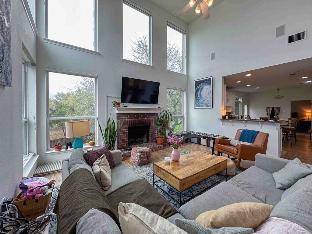 A living room with a fireplace and a television.
