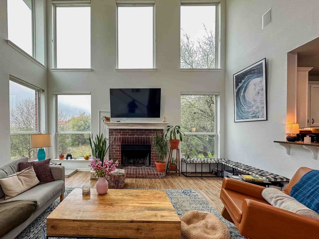 A living room with a fireplace and a flat screen TV.