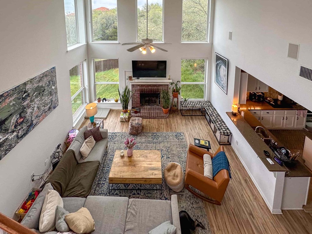 A living room with a fireplace and a television.