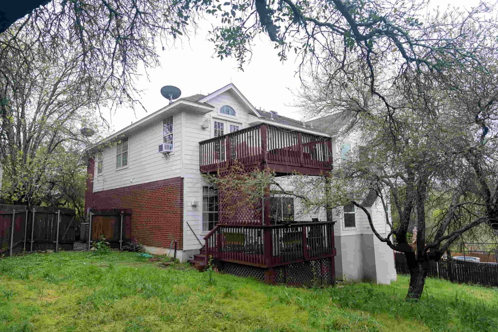 A house with a red brick exterior and a white trim.